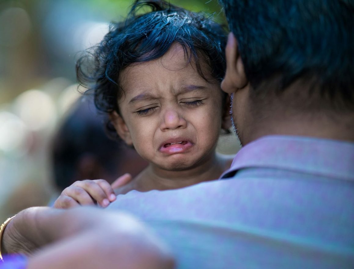 managing pain in children: a picture of someone holding a crying child