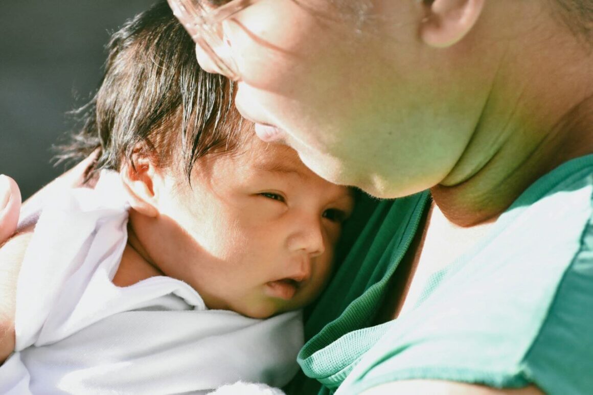 financial help for moms - picture of a woman holding a baby in philippines